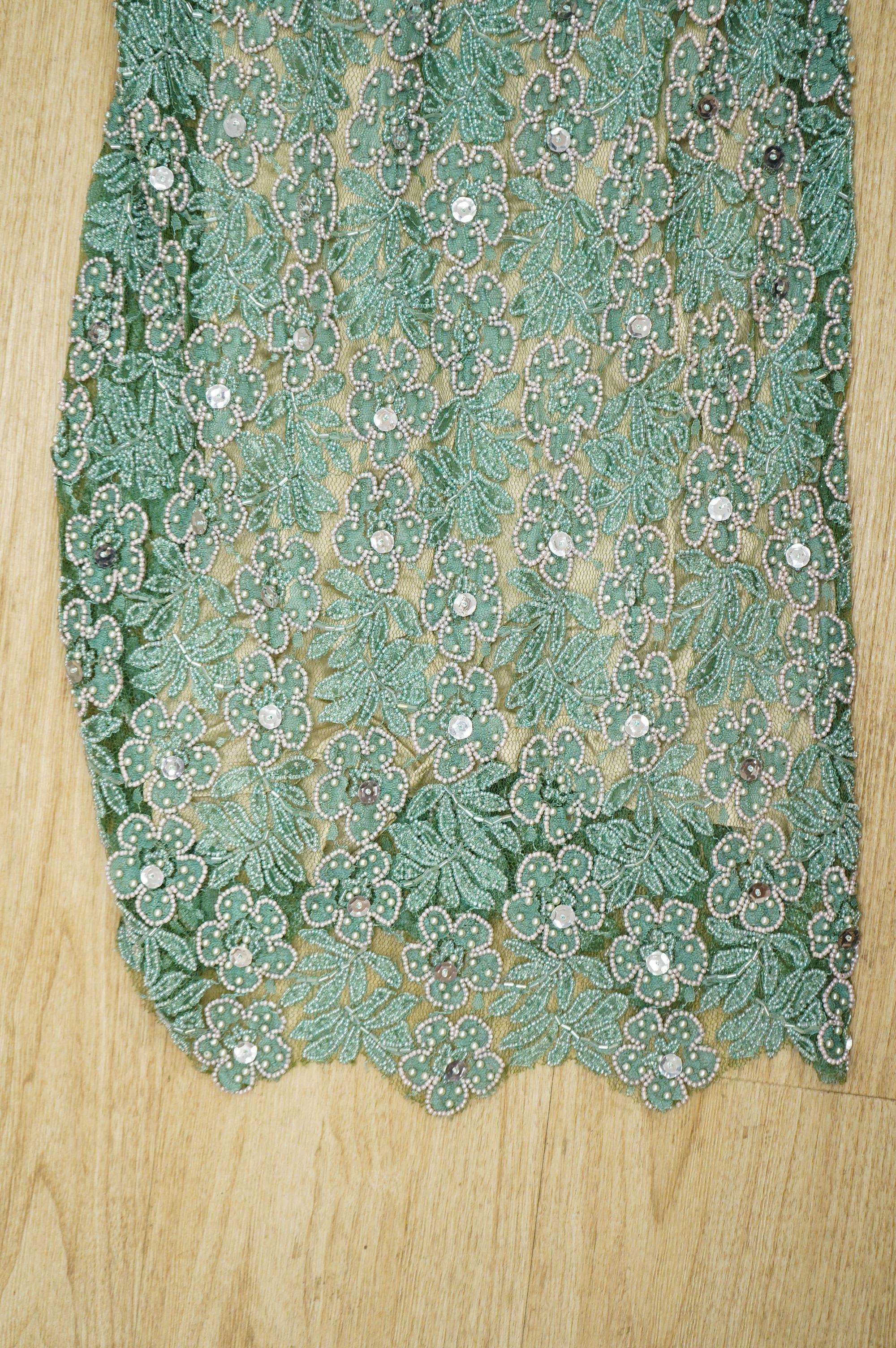 A 1960’s-70’s light green beaded and sequin floral net, fitted full length evening dress. 134cm long
